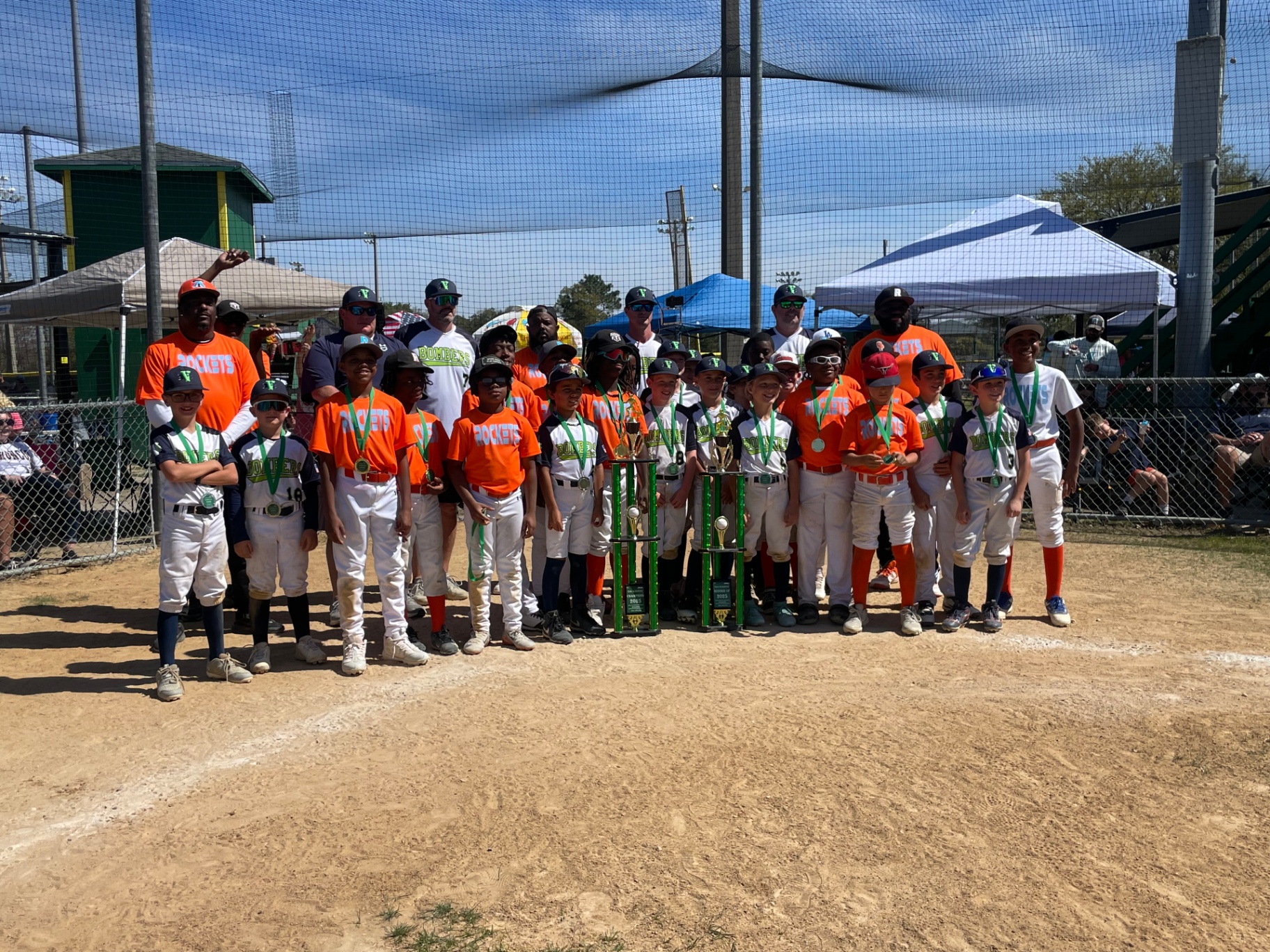 Rockets and Bombers with championship trophies