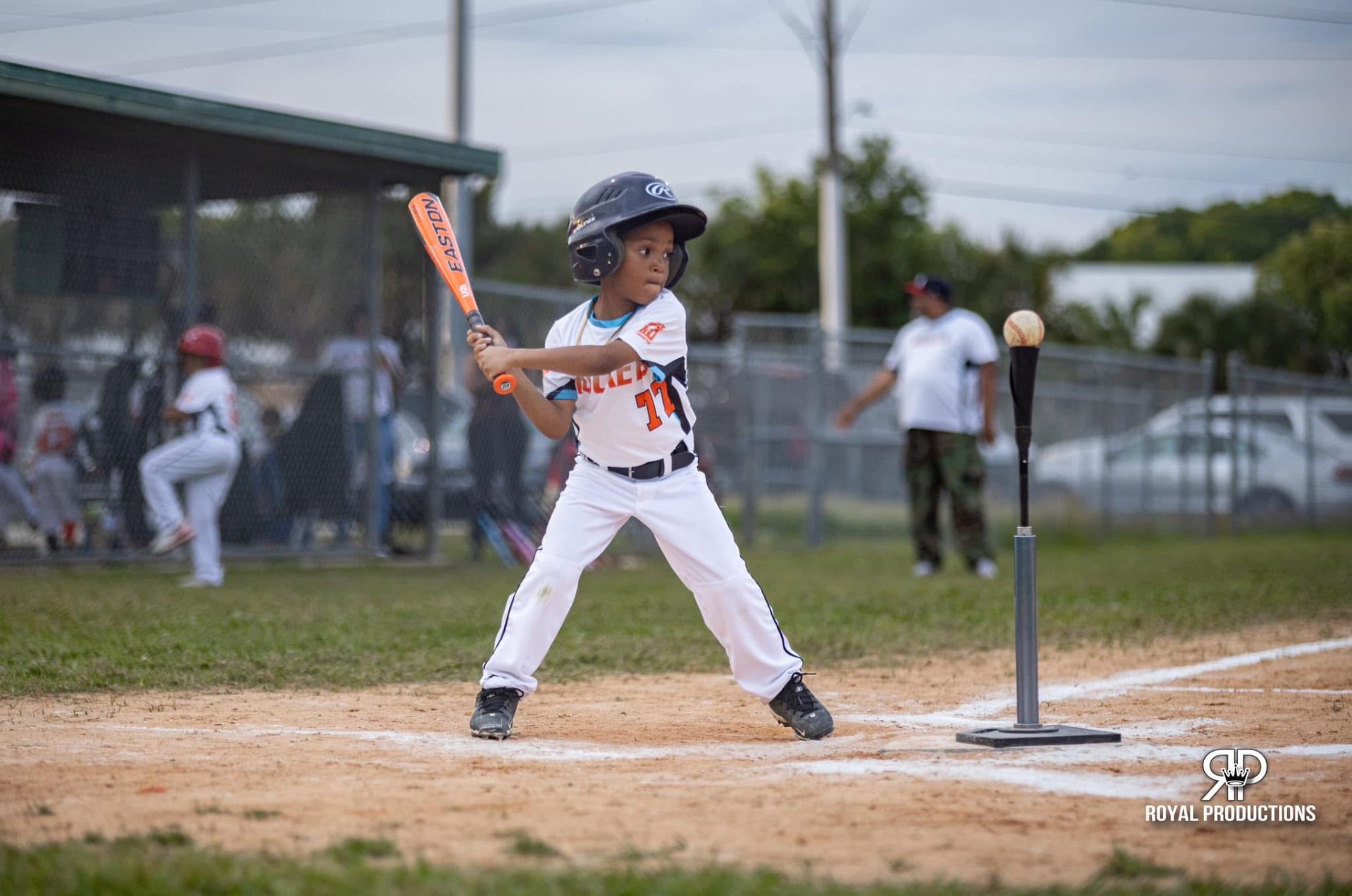 Young Rockets batter swinging at a tee ball